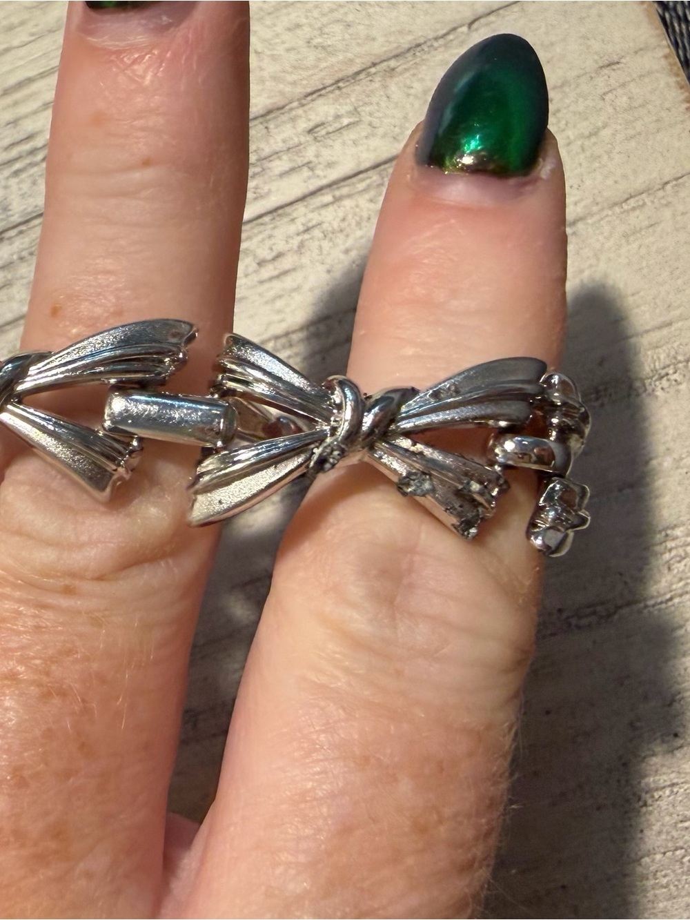 Trifari Silver Bow Link Ring has some pitting and damage